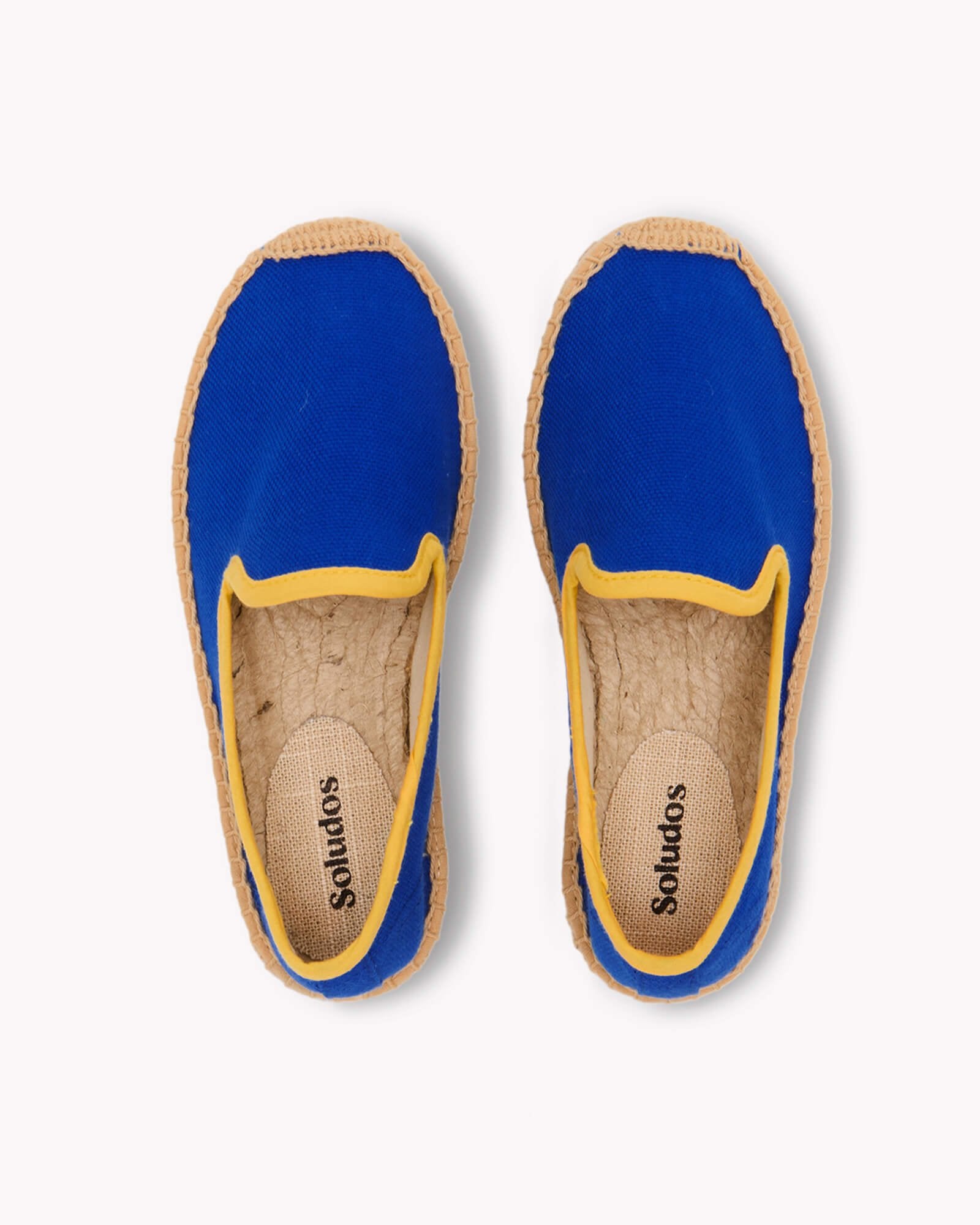 Overhead image of blue kids smoking slipper espadrille with yellow piping trim