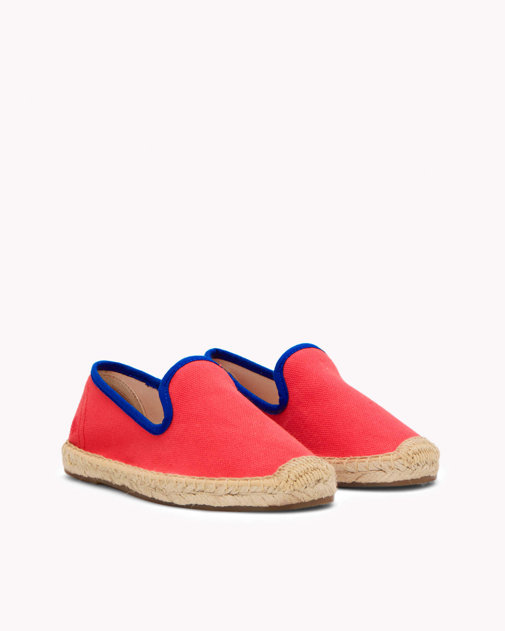 Kids red espadrille shoes with navy piping on gray background