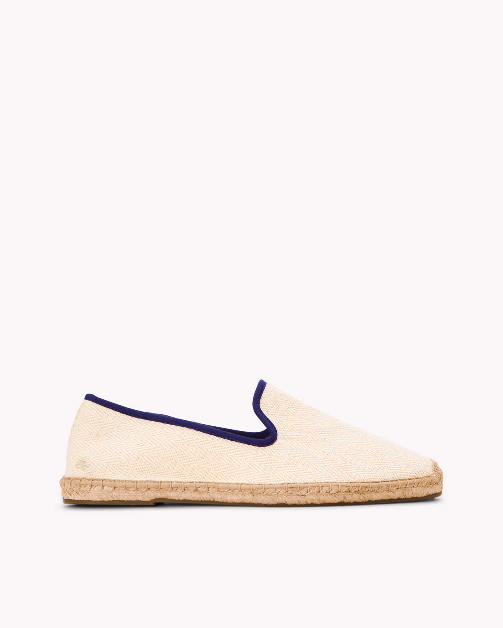 Men's ivory espadrille shoes with navy blue piping on gray background