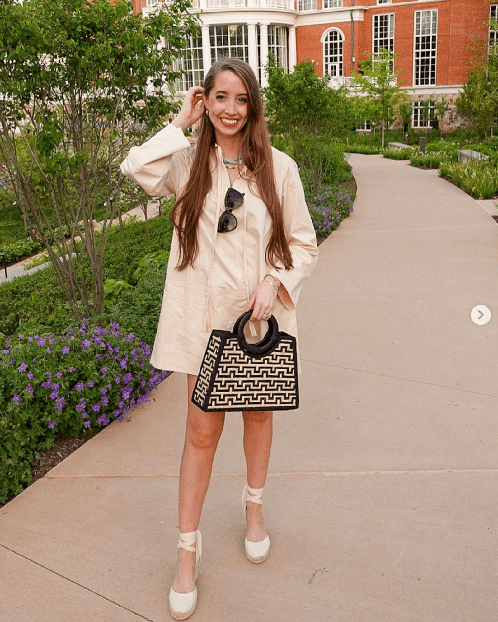 Woman wearing ivory espadrille wedges in an ivory dress shirt dress in UGC style