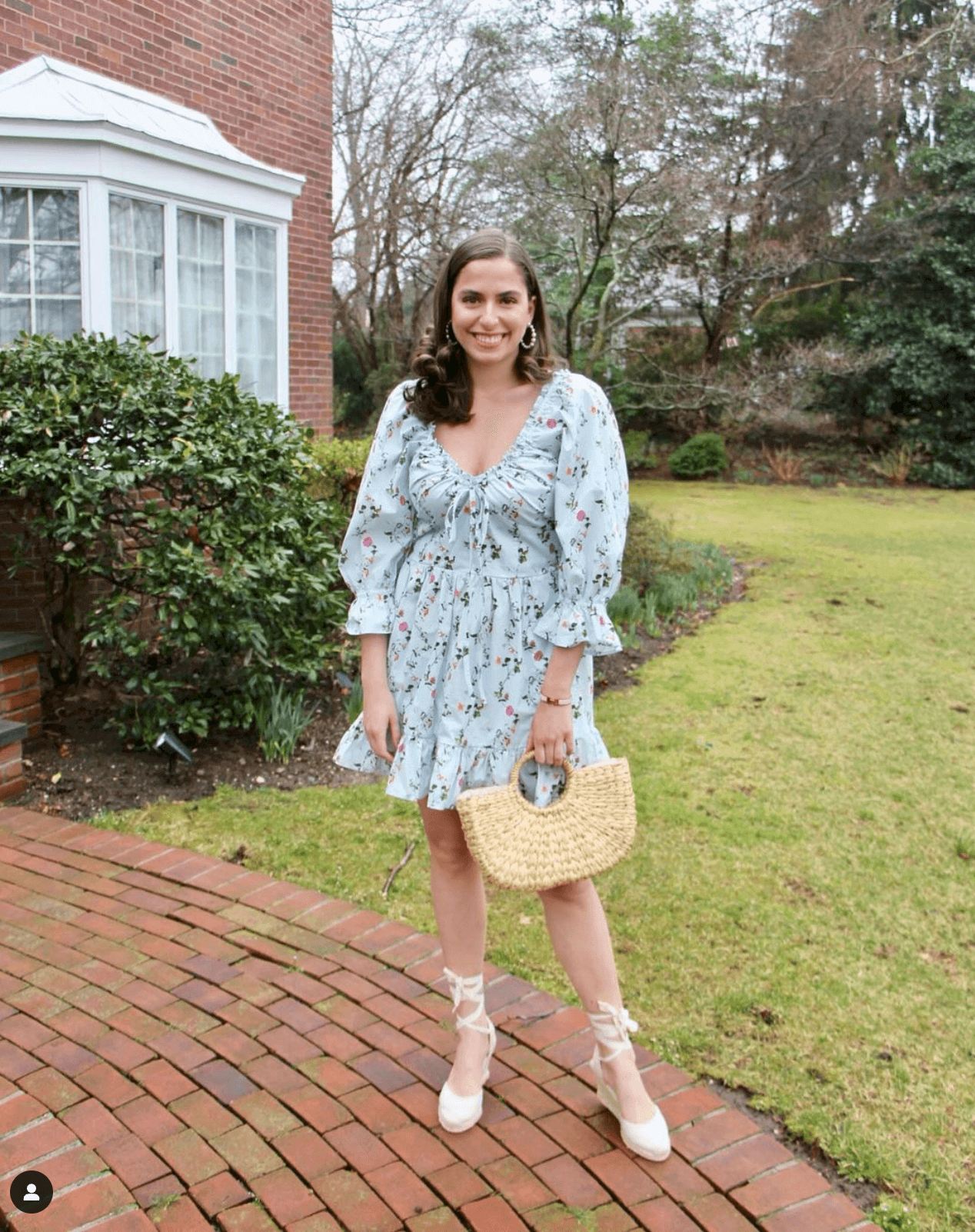 Woman wearing ivory espadrille wedges in a blue dress in UGC style