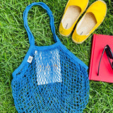 Blue mesh bag on grass