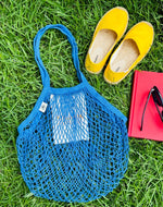 Blue mesh bag on grass
