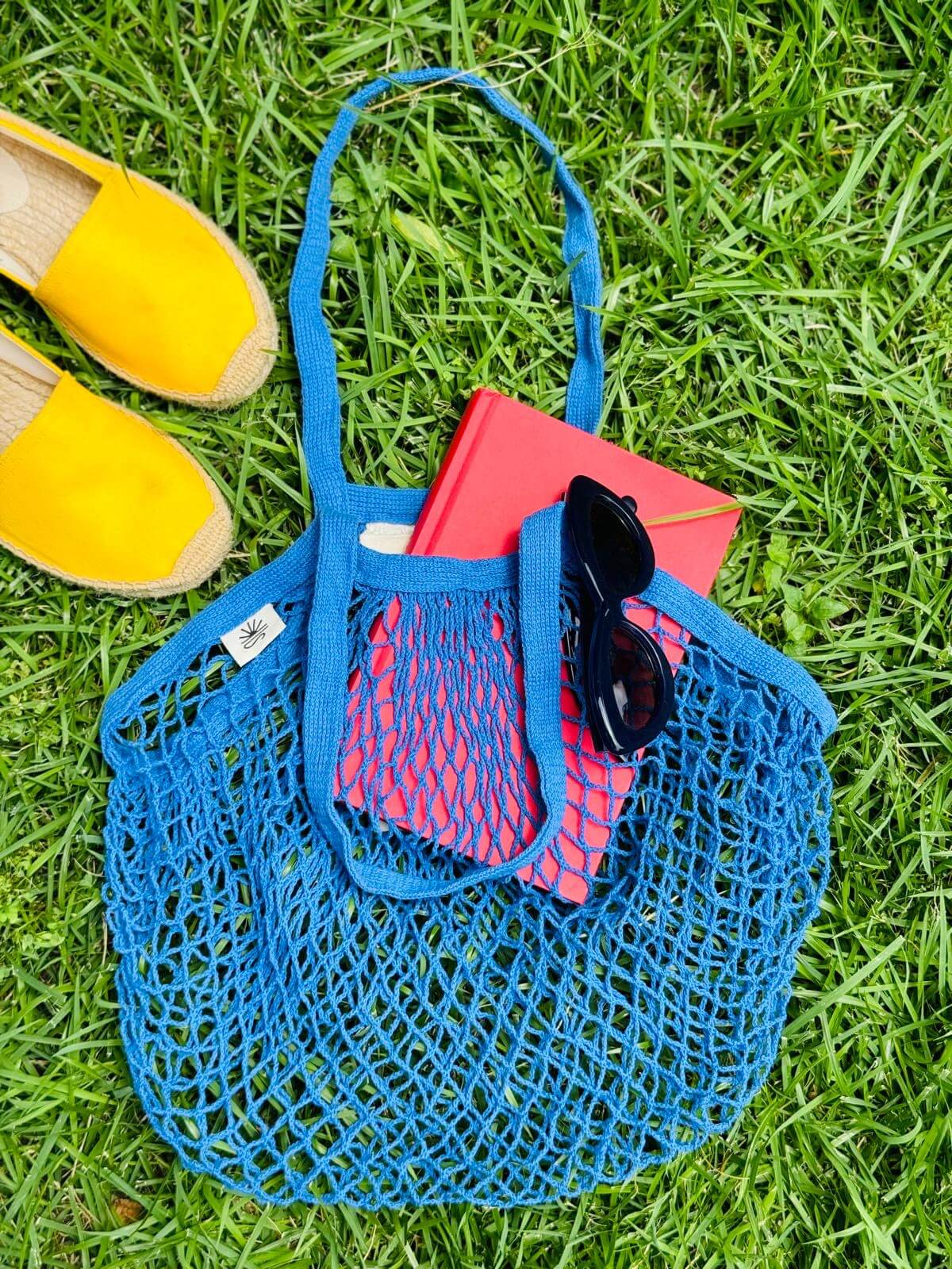 Blue bag laying on grass outside