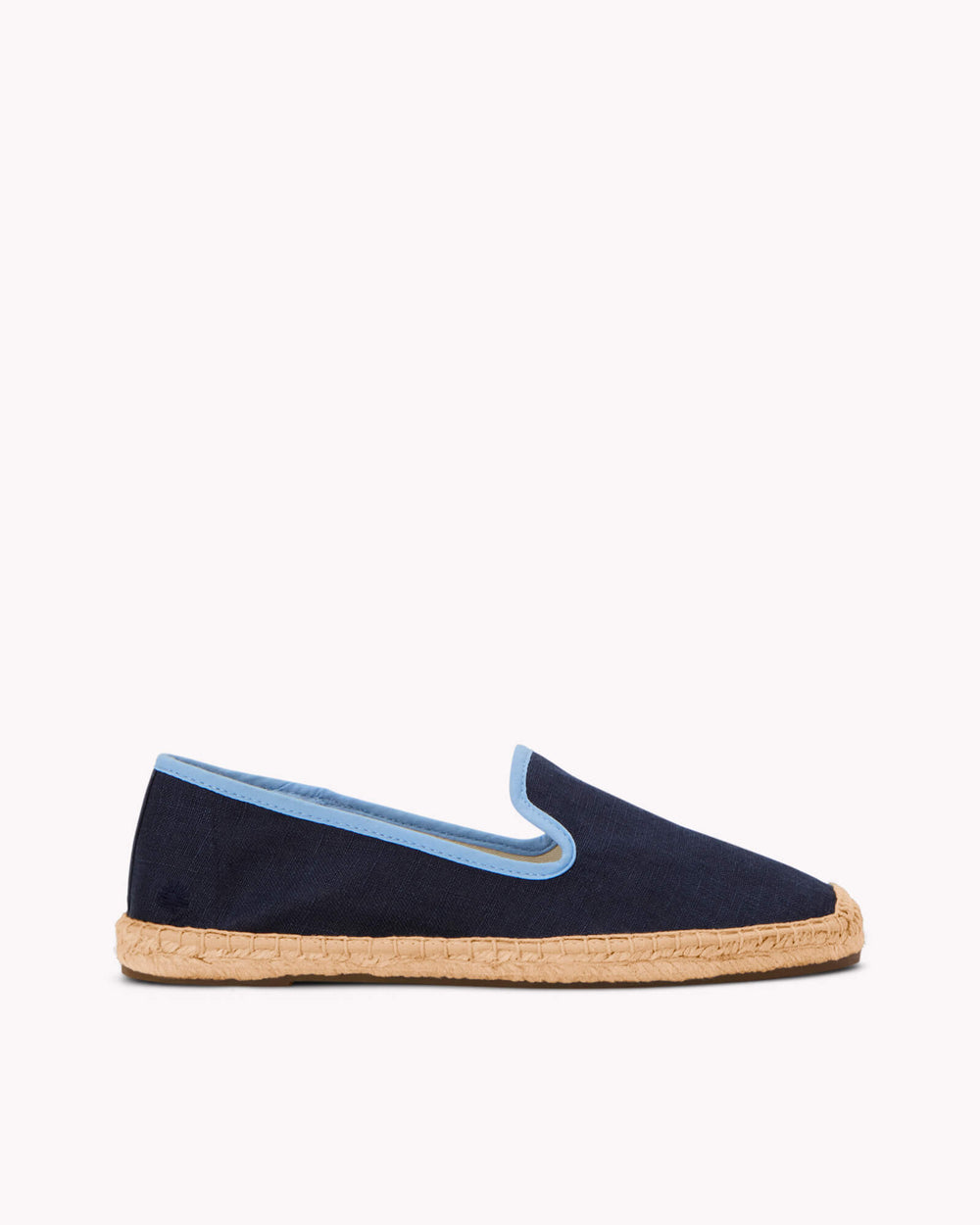 Women's navy espadrille shoes with light blue piping on gray background