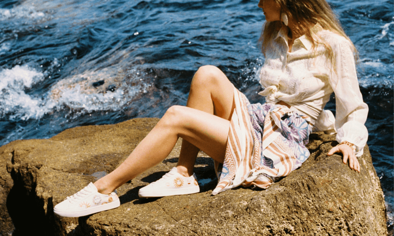 woman wearing white sneakers by the water